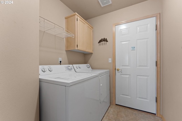 laundry room featuring independent washer and dryer and cabinets