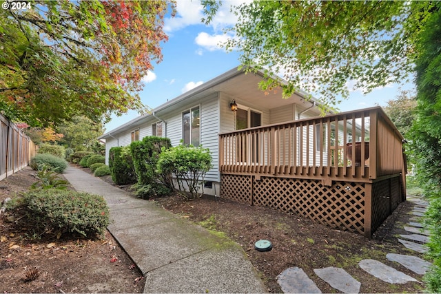 view of side of property featuring a wooden deck