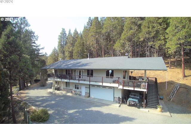 view of front of house featuring a garage and a wooden deck