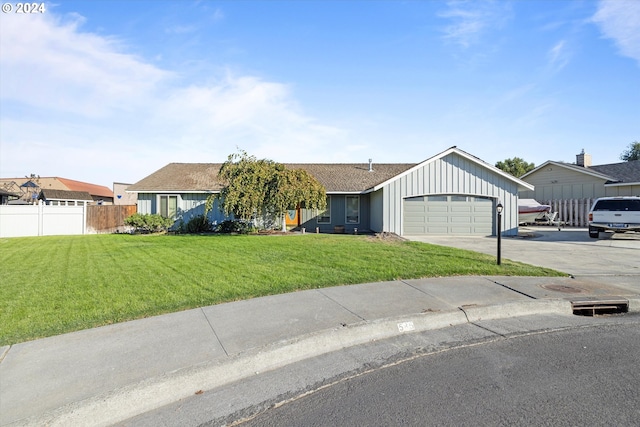 ranch-style home featuring a garage and a front yard