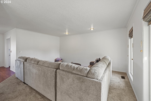 living room featuring a textured ceiling, carpet floors, and crown molding