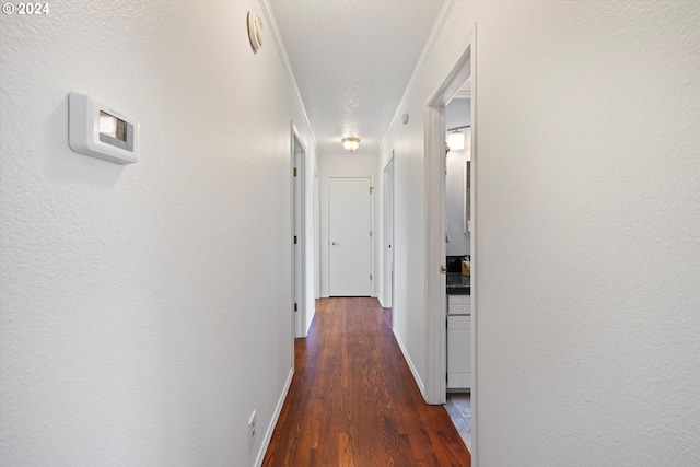 hall with dark hardwood / wood-style floors and a textured ceiling