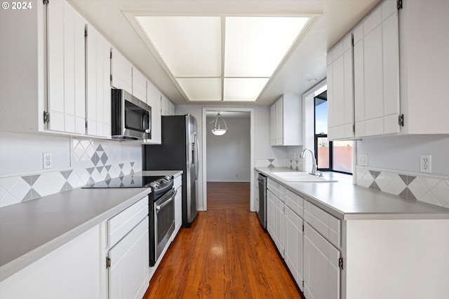 kitchen with dark hardwood / wood-style flooring, stainless steel appliances, white cabinetry, and sink