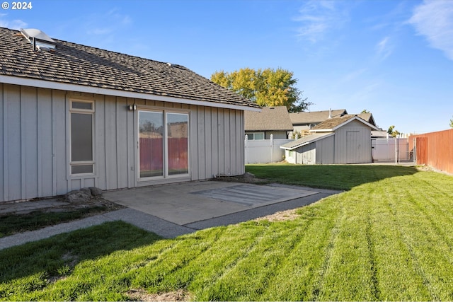 back of property featuring a lawn, a patio area, and a shed