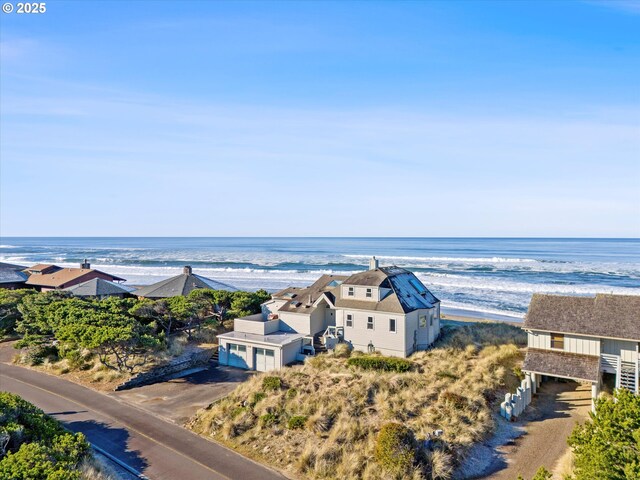 birds eye view of property with a beach view and a water view