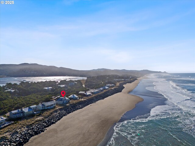 aerial view featuring a beach view and a water and mountain view