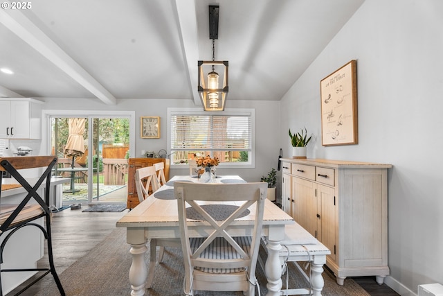 dining space with vaulted ceiling with beams, dark hardwood / wood-style floors, and a healthy amount of sunlight