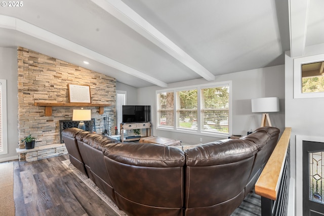 living room with dark hardwood / wood-style flooring, vaulted ceiling with beams, a wealth of natural light, and a fireplace