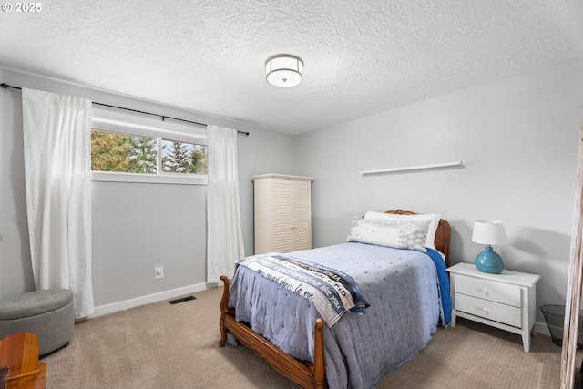 carpeted bedroom featuring a textured ceiling