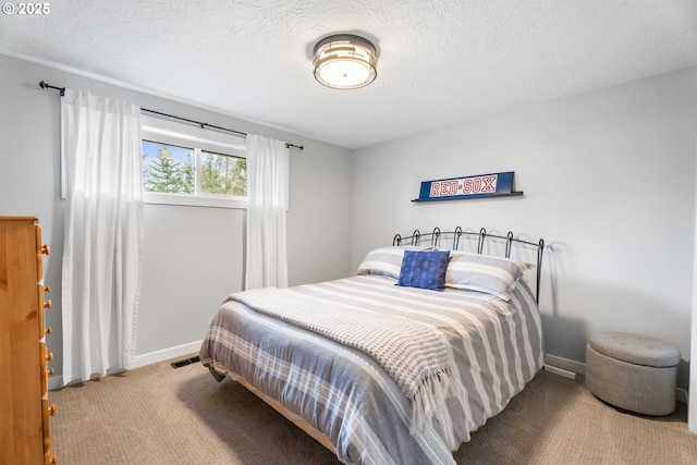 carpeted bedroom featuring a textured ceiling