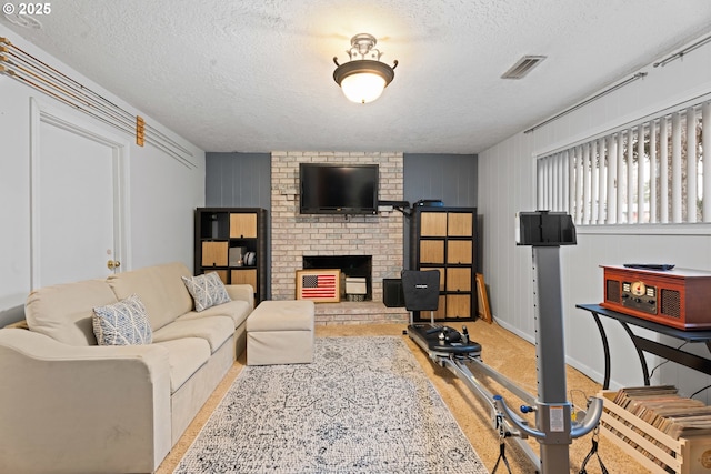 living room featuring a fireplace, light carpet, and a textured ceiling