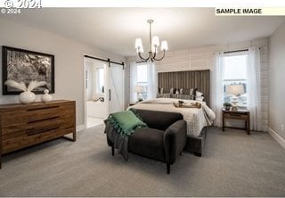 carpeted bedroom with a chandelier and a barn door