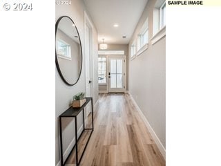 hallway featuring light hardwood / wood-style flooring and french doors