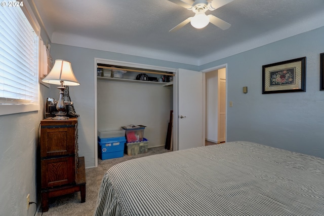 bedroom with light carpet, a closet, and ceiling fan