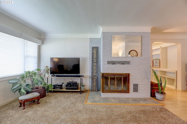 living room with hardwood / wood-style floors and a fireplace