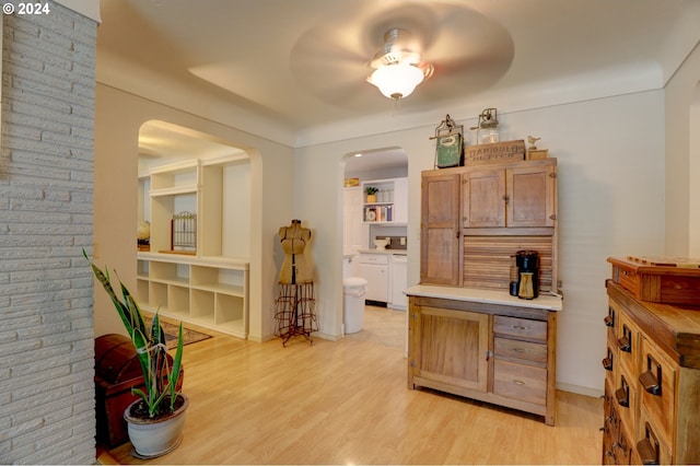 kitchen with ceiling fan, light wood-type flooring, and built in shelves