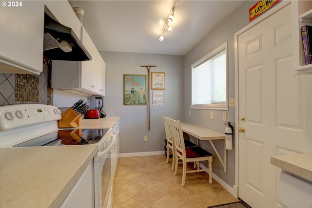 kitchen featuring white cabinets, track lighting, range hood, and white electric stove