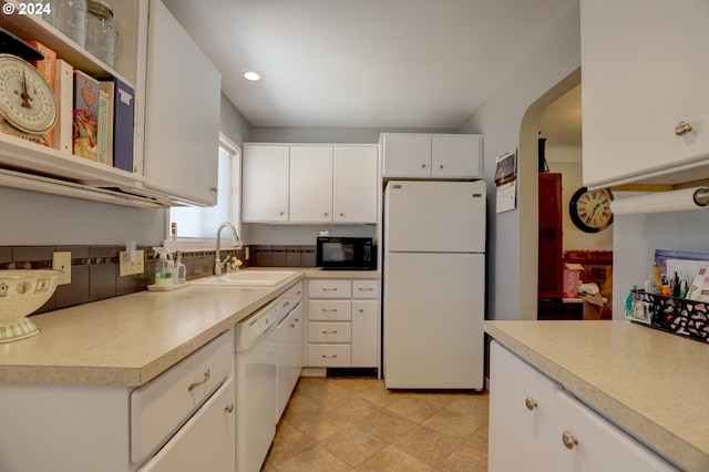 kitchen with white cabinets, white appliances, and sink