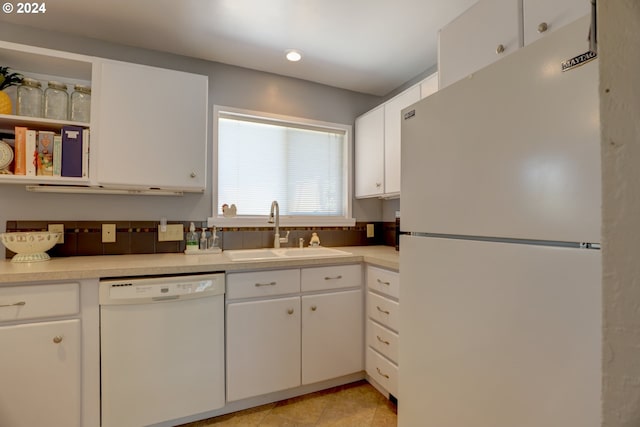 kitchen featuring white cabinetry, white appliances, and sink