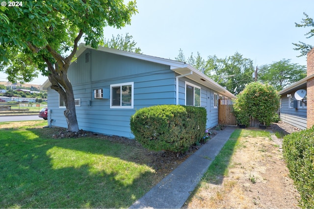 view of property exterior with a yard