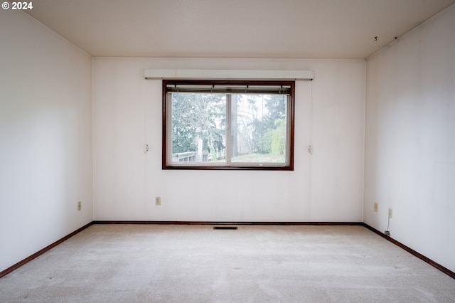 empty room featuring light colored carpet