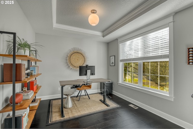 office featuring dark hardwood / wood-style flooring, a raised ceiling, ornamental molding, and a textured ceiling