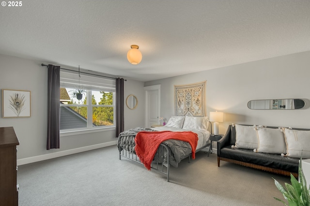 bedroom featuring carpet floors and a textured ceiling