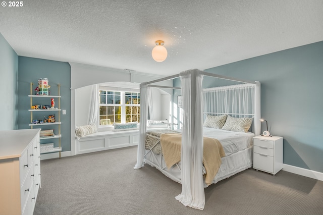 bedroom with carpet floors and a textured ceiling