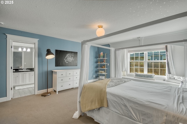 carpeted bedroom featuring sink, a textured ceiling, and connected bathroom