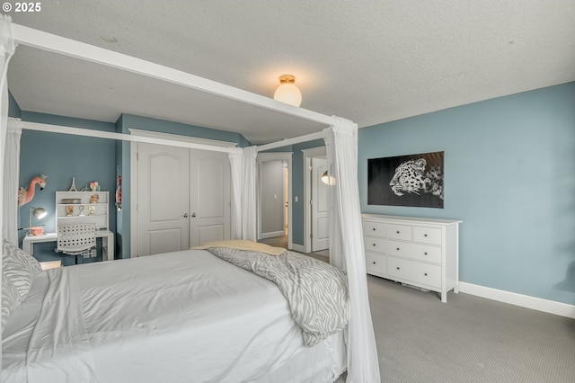 bedroom with a closet, light colored carpet, and a textured ceiling