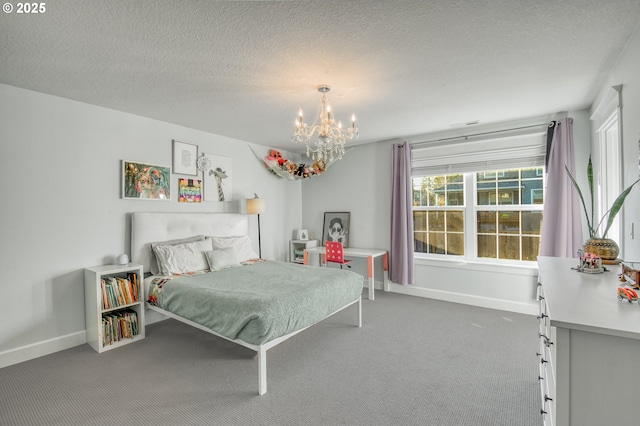 carpeted bedroom featuring a chandelier and a textured ceiling