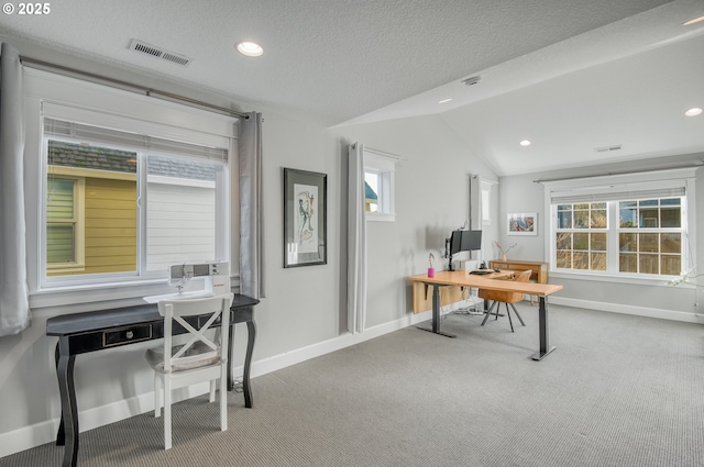 office area featuring a textured ceiling, carpet floors, and vaulted ceiling