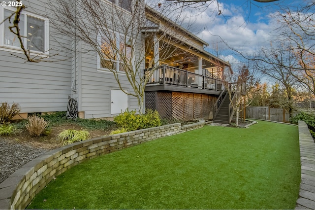 view of yard featuring a deck and ceiling fan