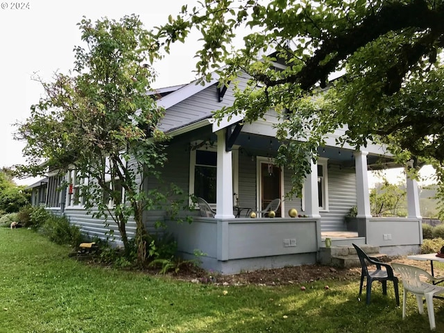 view of side of home with a yard