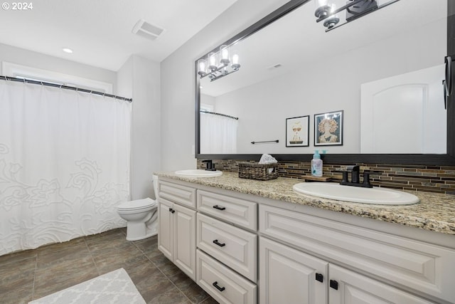 full bathroom with toilet, visible vents, backsplash, and a sink