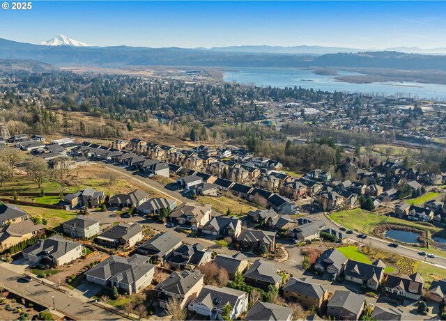 bird's eye view with a water and mountain view