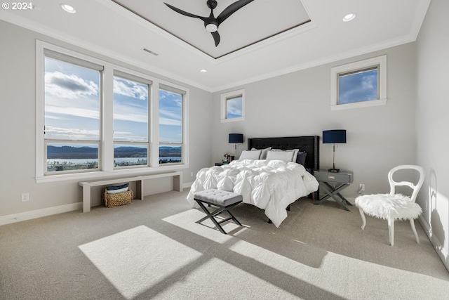 carpeted bedroom featuring visible vents, a tray ceiling, recessed lighting, crown molding, and baseboards