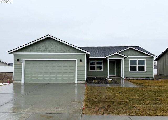 view of front facade with a garage and a front lawn