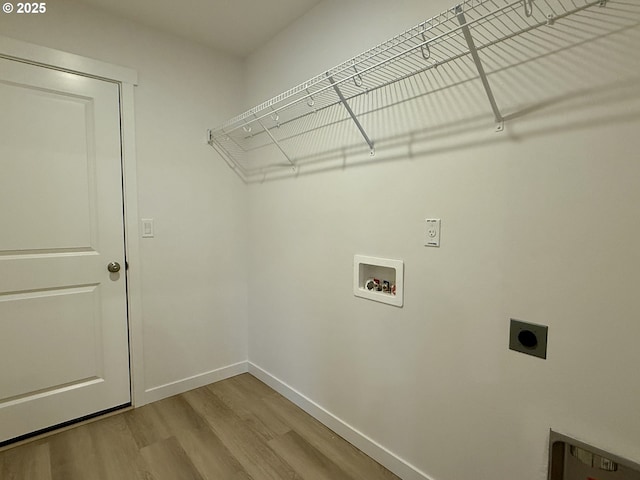 laundry room featuring hookup for a washing machine, laundry area, wood finished floors, baseboards, and electric dryer hookup