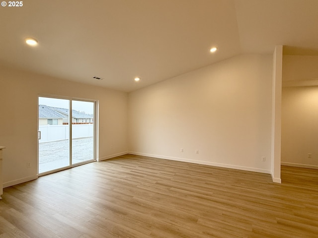 unfurnished room with lofted ceiling, recessed lighting, visible vents, light wood-style flooring, and baseboards