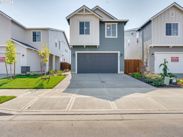 view of front of property with a front yard and a garage