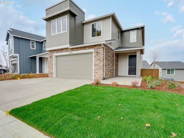 contemporary home with a garage and a front yard