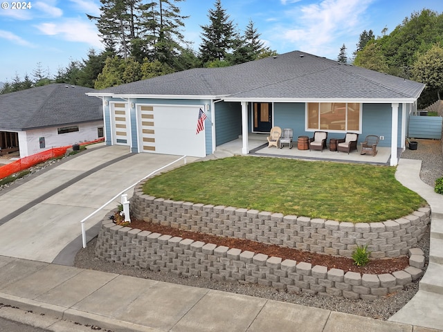 ranch-style home with roof with shingles, concrete driveway, outdoor lounge area, a front yard, and a garage