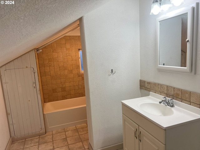 bathroom featuring tiled shower / bath combo and vanity