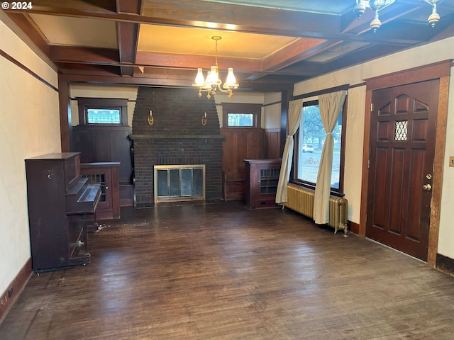 living room featuring a healthy amount of sunlight, radiator heating unit, a fireplace, and coffered ceiling