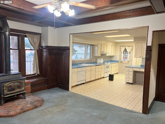 kitchen featuring light colored carpet, a healthy amount of sunlight, and white appliances