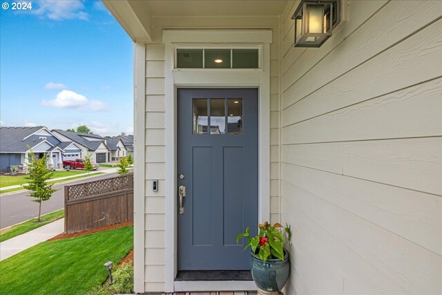 entrance to property featuring a yard