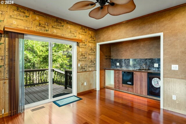 entryway with crown molding, hardwood / wood-style floors, and sink