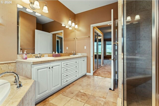 bathroom with vanity and independent shower and bath