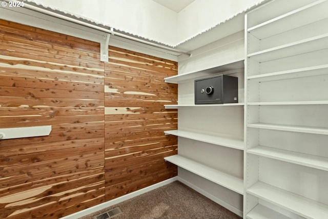 walk in closet with carpet